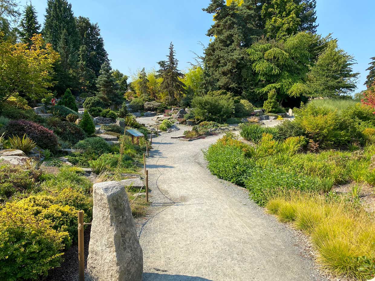Rock Garden at Bellevue Botanical Garden featuring a winding path through native stone arrangements, lush foliage, and kid-friendly stepping stones—great for exploring nature up close with children.