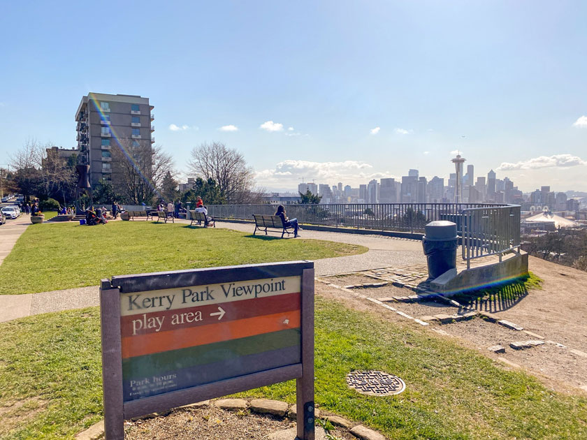 Kerry Park viewpoint sign at the entrance of this small grassy park perched on a hilltop, offering breathtaking views of the Seattle skyline, including the Space Needle and Mount Rainier in the distance. A popular destination for visitors and locals alike to take in iconic cityscapes.