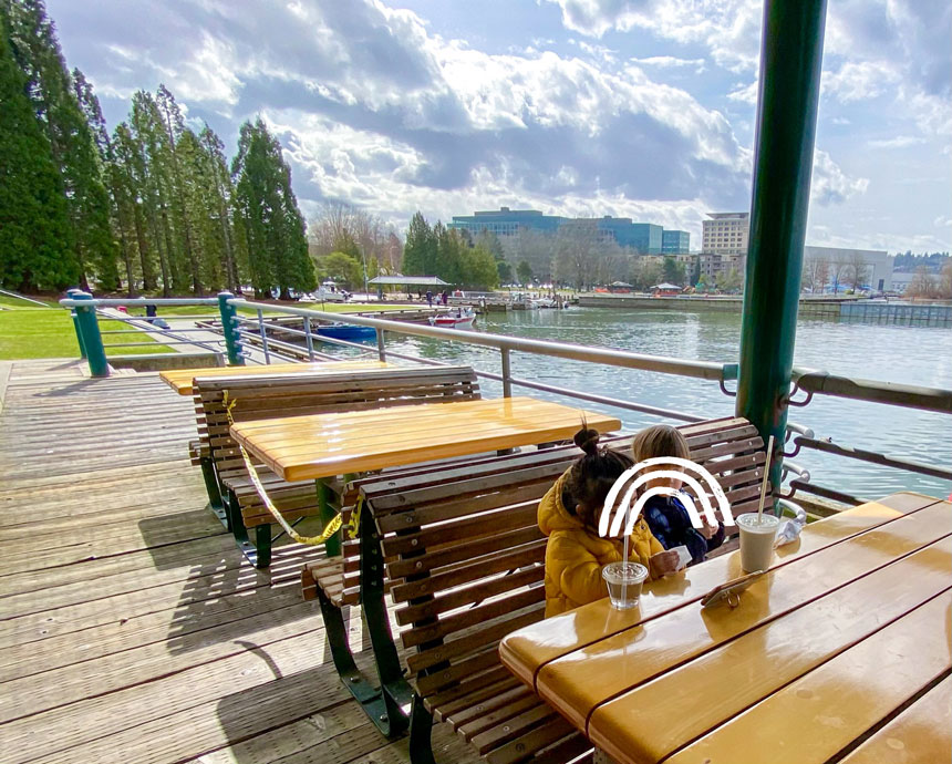 Gene Coulon Memorial Beach Park Picnic Table with Waterfront View and two fast food restaurants on the dock.