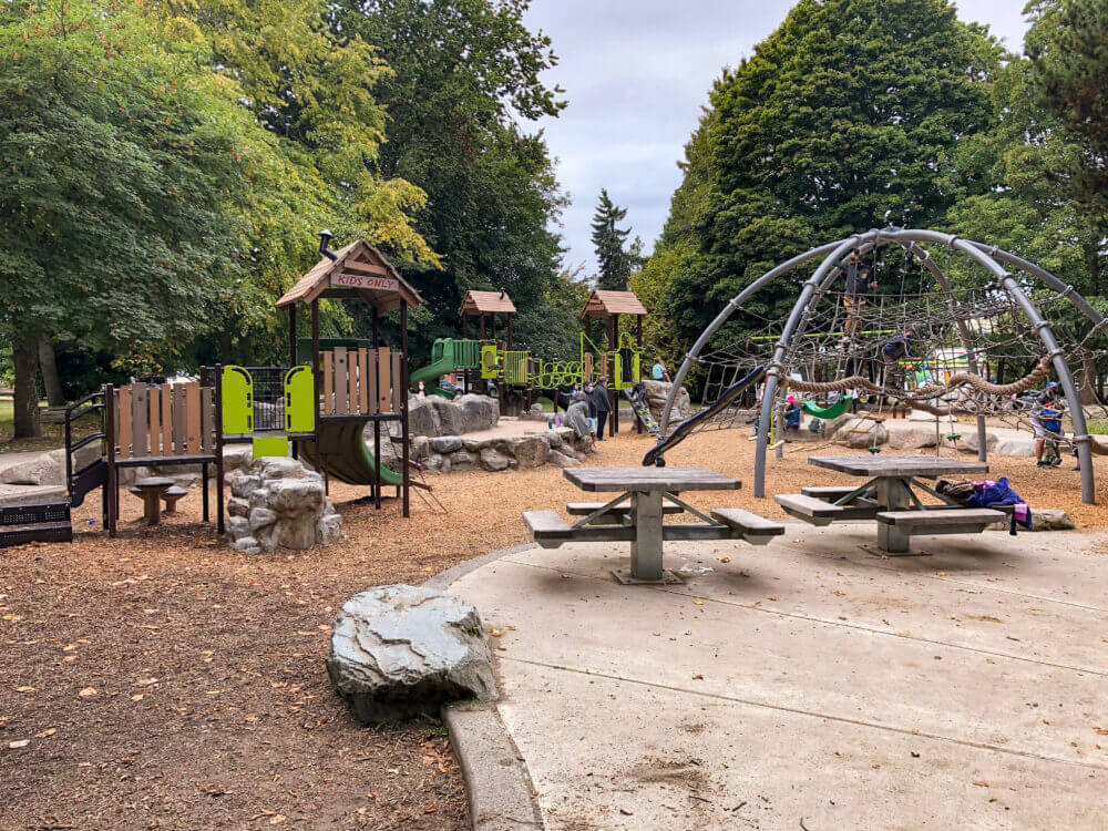 Kids playing at West Woodland Park Playground in Seattle, enjoying the climbing structures and open space—featured in our guide to the best parks and playgrounds in Seattle for kids.