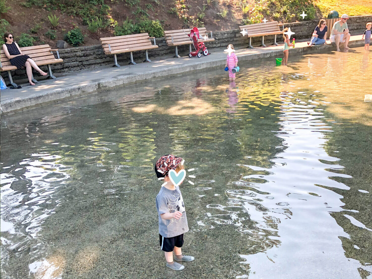 Kids playing in the summer at Soundview Playfield Wading Pool in Seattle.
