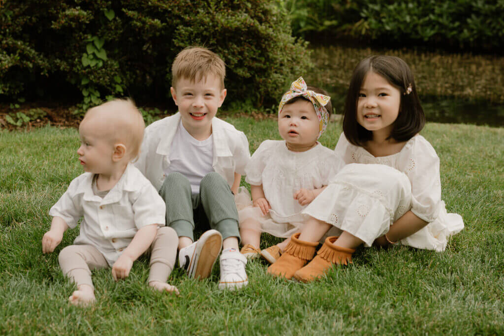 Four young cousins – two boys and two girls – huddled together with big smiles, capturing the spirit of family adventures. These inseparable travel buddies are the heart of our blog, sharing joyful moments from parks, playgrounds, and epic vacations across the Pacific Northwest and beyond.