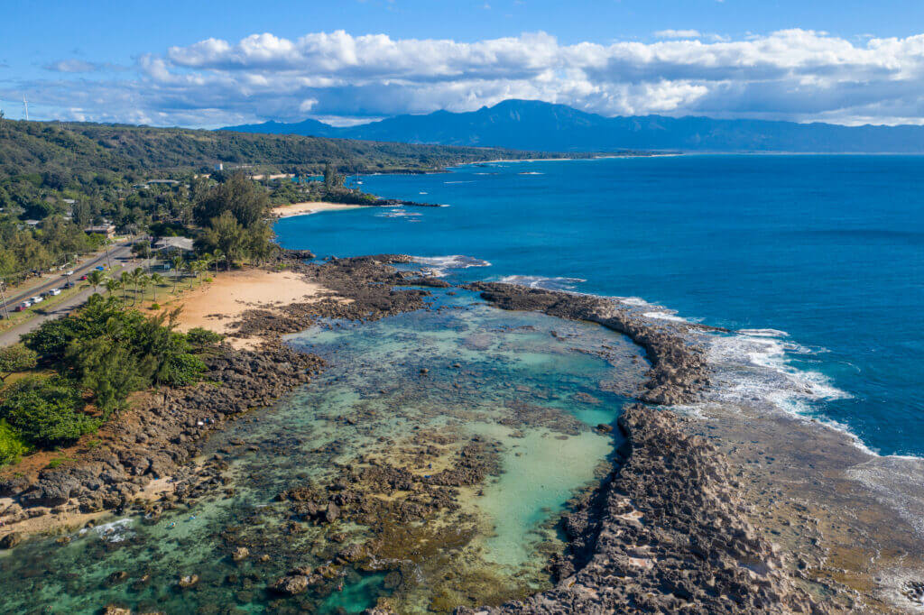 Sharks Cove a famous Oahu Beach in North Shore Hawaii, known for its tide pools and marine life, kids can walk on the rocks and look into the water