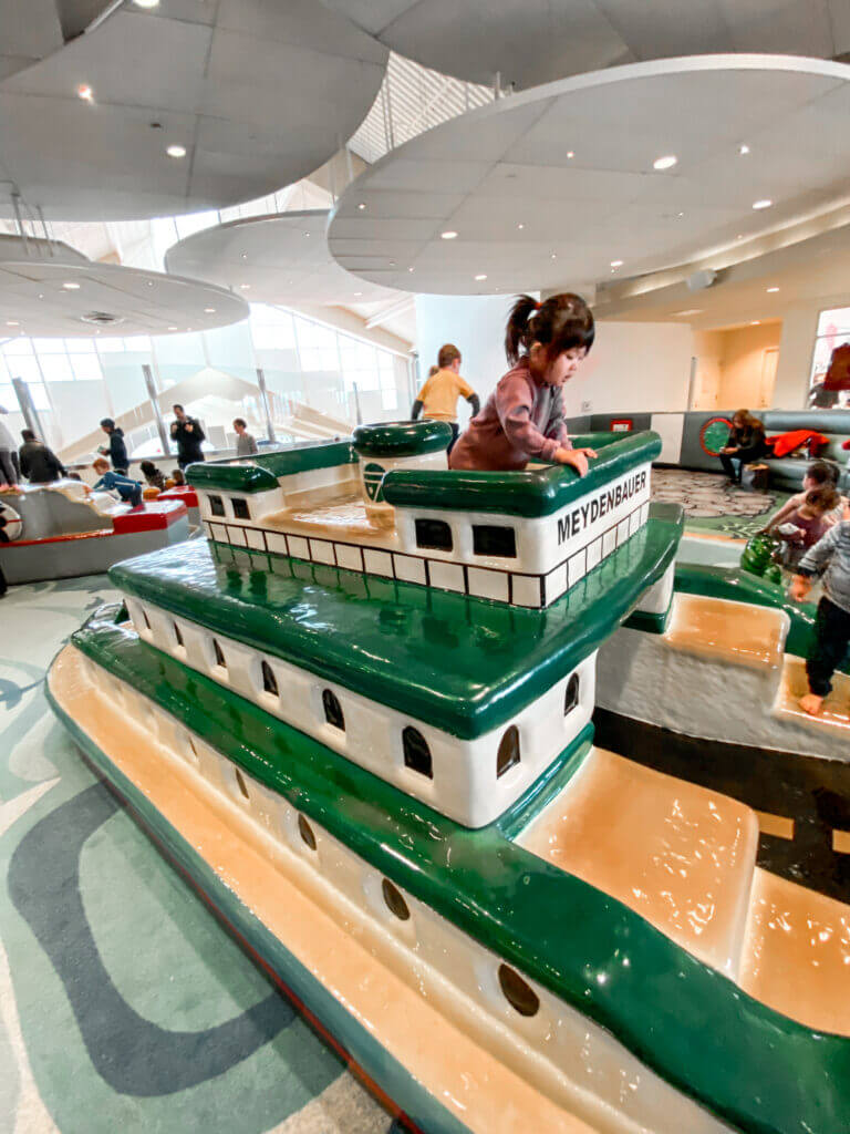 Bellevue Square Kid's Cove Indoor Playground for toddlers, young girl on a boat