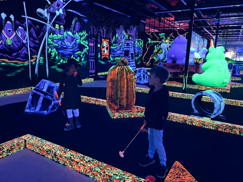 Monster Mini Golf in Factoria Bellevue, a darkened 18-hole miniature golf course, aglow with funky blacklights.
