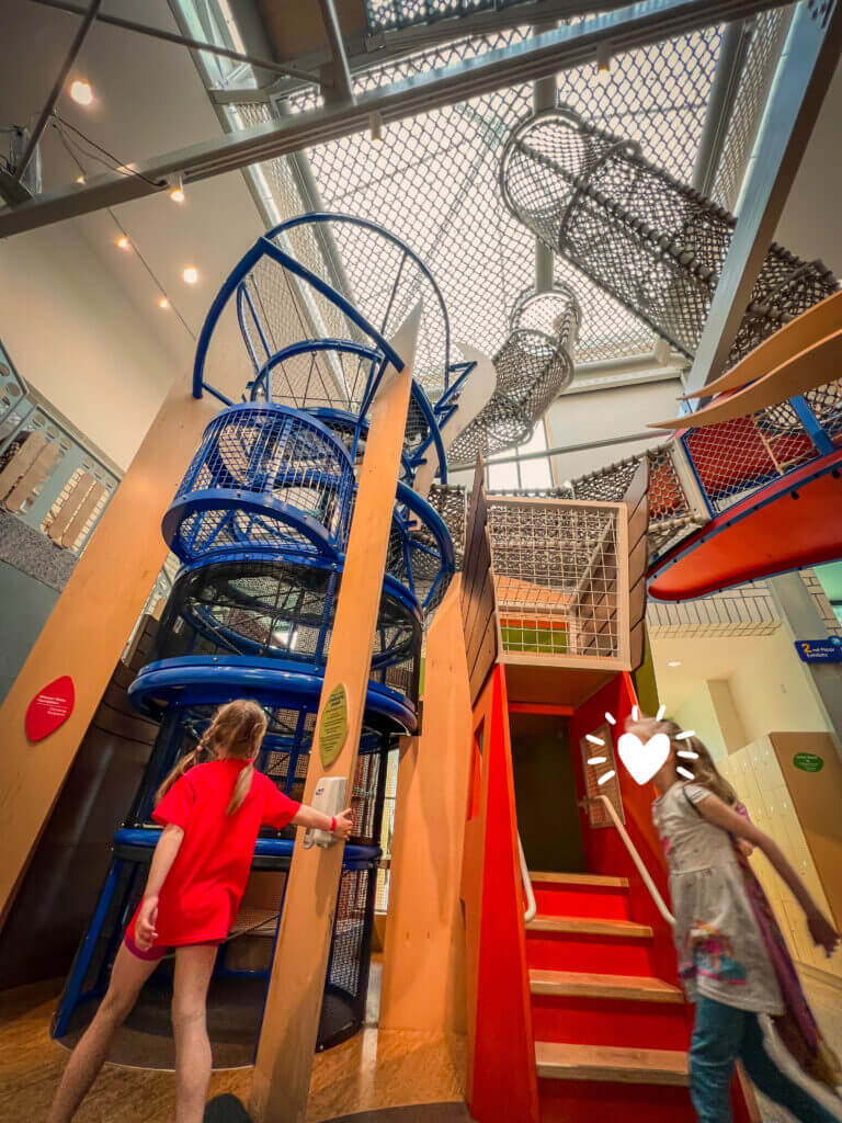 The Atrium Climber at KidsQuest Children’s Museum in Bellevue is the museum’s largest and most iconic exhibit, spanning two stories of exciting climbing fun. Kids can explore through tunnels, platforms, and nets as they navigate this towering structure, encouraging physical activity, problem-solving, and confidence. A highlight for many families, the Atrium Climber offers a safe and adventurous way for children to play, climb, and discover.