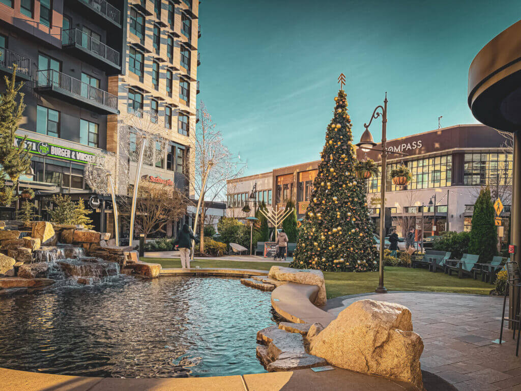 Holidays at The Village at Totem Lake bring festive cheer with a beautifully decorated outdoor Christmas tree near Salt & Straw. Kids can run around and play on the turf while enjoying the holiday lights and seasonal decorations. The area also features fun toy spinning equipment, creating a lively and family-friendly space for parents and children to soak in the holiday spirit.