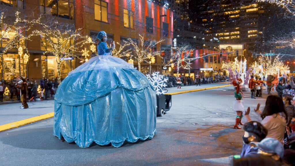 Snowflake Lane in downtown Bellevue during the holidays, featuring festive lights, costumed performers, and falling faux snow. This free family-friendly event is one of the top things to do with kids in Bellevue during the holiday season.