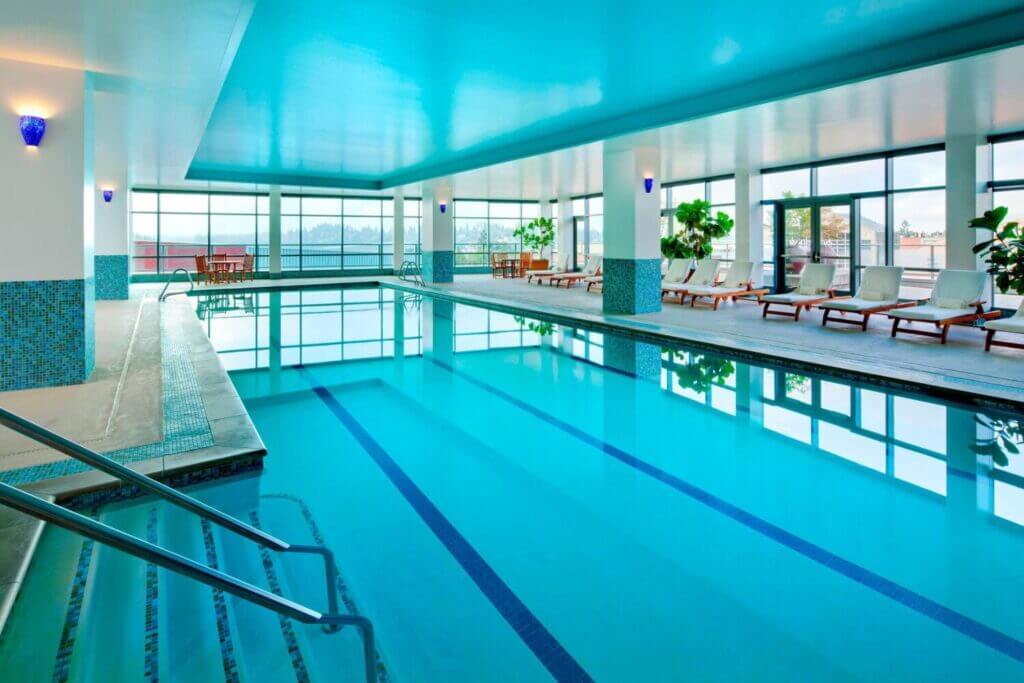 The Westin Bellevue indoor pool with large windows letting in natural light, perfect for families looking to relax after exploring downtown Bellevue—featured in our blog on the best places to stay with kids near Seattle.