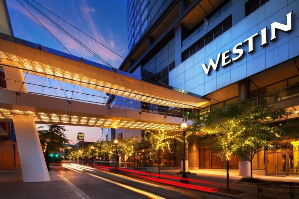 Exterior view of The Westin Bellevue, showcasing its sleek modern architecture and the convenient overhead pedestrian bridge connecting the hotel directly to Bellevue Square shopping center—making it one of the best places to stay in Bellevue with kids.