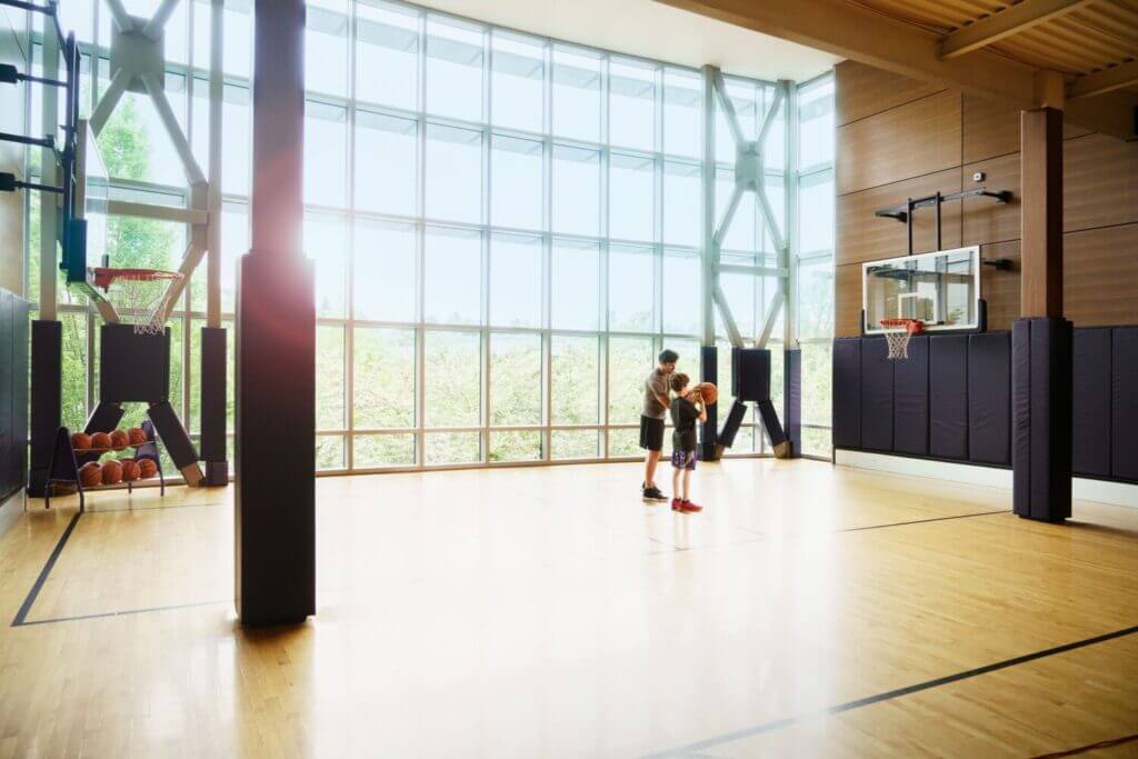Bellevue Club Hotel indoor basketball court featuring a full-size court with polished wood flooring and professional hoops, a great way for active families and kids to stay entertained during their stay.