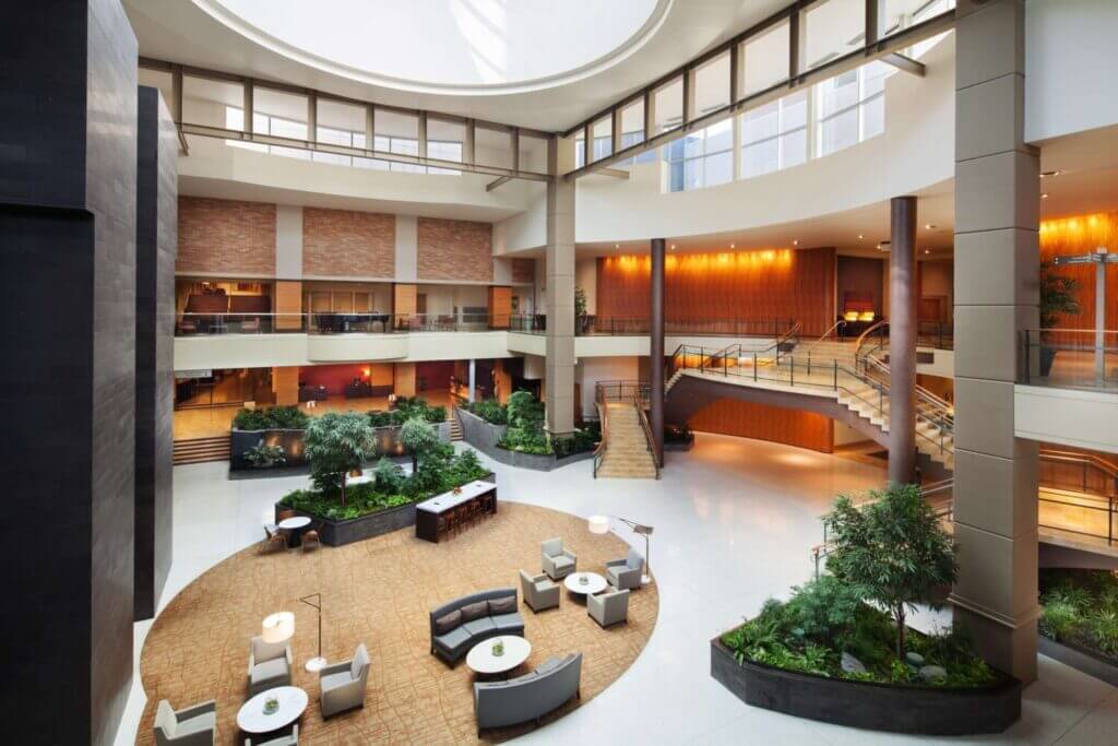 Hyatt Regency Bellevue expansive lobby, featuring elegant modern design with high ceilings, natural wood accents, and cozy seating areas—perfect for families looking for comfort and convenience in one of the best places to stay in Bellevue with kids.