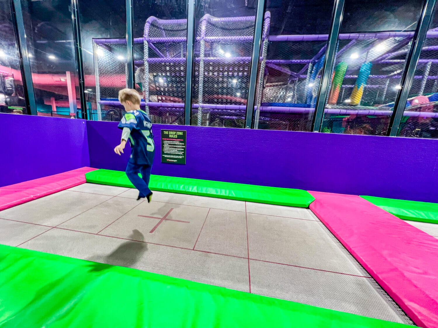 A 5-year-old joyfully jumping at Flying Squirrel Trampoline Park near Seattle, enjoying the fun and energetic indoor play space.