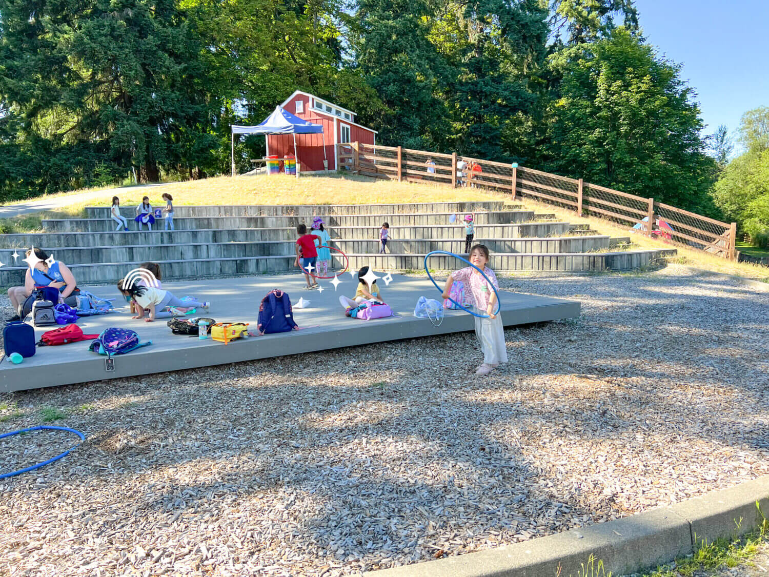 At Kelsey Creek Farm’s summer camp in Bellevue, kids enjoy hands-on outdoor fun, including drawing with colorful chalk on the pathways surrounded by nature and the sounds of farm animals. This popular camp blends classic childhood creativity with educational experiences, allowing kids to interact with animals like goats, chickens, and bunnies while also participating in art, nature walks, and group games. It’s a beloved local program that offers a well-rounded mix of learning and play, making it a fantastic option for families looking for enriching summer activities near Seattle.
