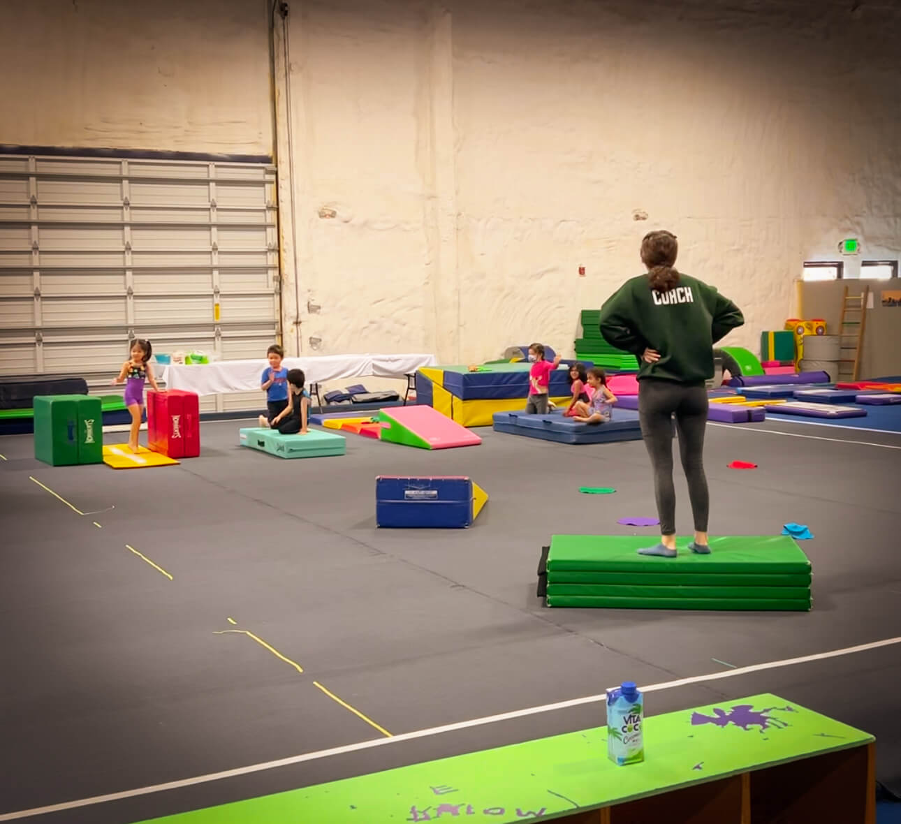 Gymnastics Connection summer camp provides a fun, high-energy environment where young kids can build strength, coordination, and confidence through movement. In this image, a group of little campers is seen actively engaged, following along with their coach during a structured gymnastics session. With padded floors, colorful equipment, and supportive instructors, kids are introduced to skills like balance, tumbling, jumping, and stretching—all tailored to their age and ability levels. Located in the greater Seattle and Eastside area, Gymnastics Connection’s camps offer the perfect balance of play and learning, making it a top pick for families looking for a summer camp that keeps kids active and smiling.