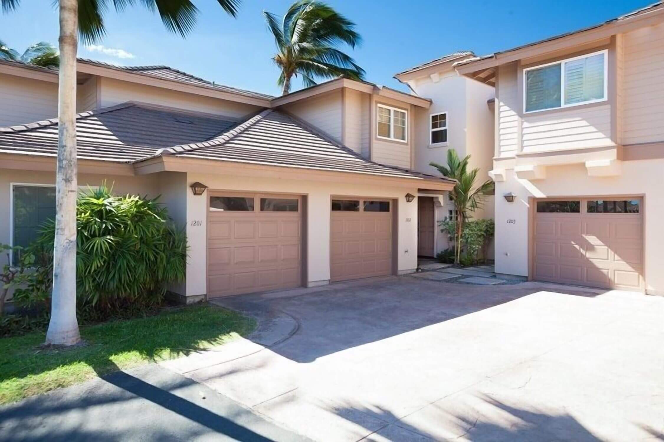 Exterior view of Waikoloa Colony Villas on the Kona side of the Big Island, showcasing the well-maintained tropical landscaping, private lanais, and multi-level townhome-style vacation rentals. This gated community is a top pick in our family travel blog for its spacious accommodations, quiet atmosphere, and access to pools, golf courses, and nearby beaches—perfect for families traveling with kids.