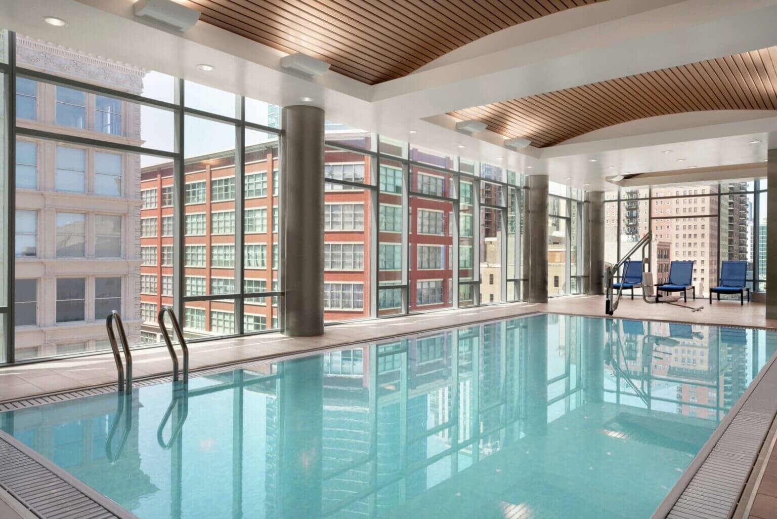 Homewood Suites by Hilton hotel room with kitchenette, featuring a full-size fridge, microwave, stovetop, sink, and dining area—perfect for families traveling with kids who want to prepare simple meals or snacks.