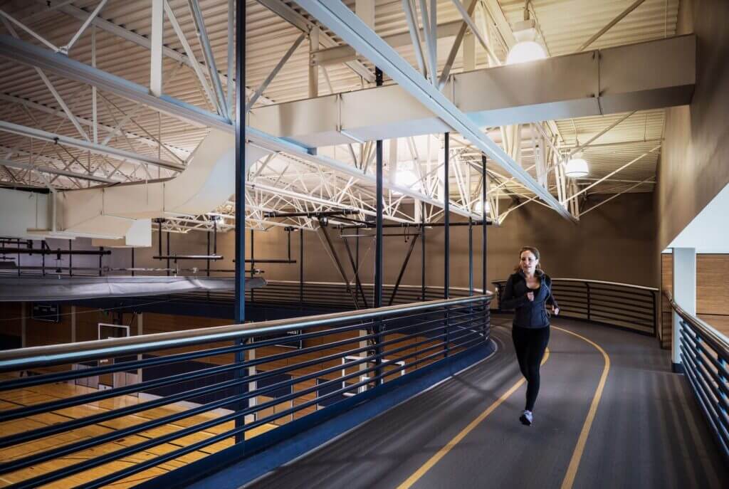 Indoor running track at the Bellevue Club Hotel, elevated above the basketball courts, offering a unique space for guests to jog or walk in a climate-controlled environment—perfect for active families visiting Bellevue.